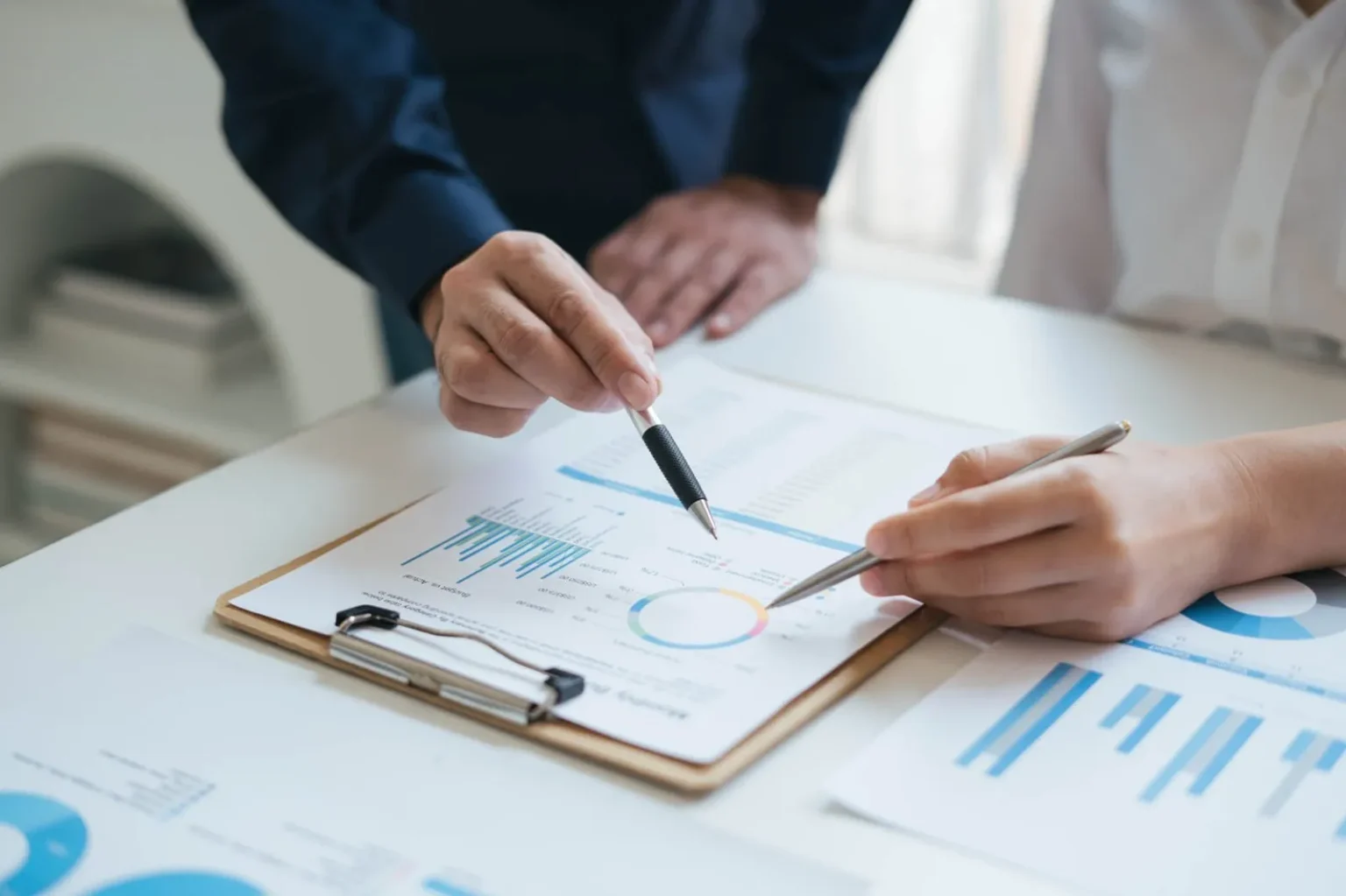 business-sales-consultant-discussing-in-data-documents-at-modern-office--1536x1023